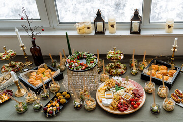 On the table, there is a wide variety of different types of food, showcasing an assortment of dishes and presenting a delightful buffet for everyone to enjoy and explore culinary delights