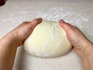 woman's hands kneading dough, baking, pizza dough