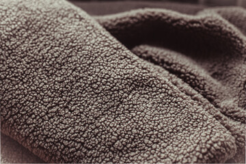 Color of the Year 2025 Mocha Mousse color. Chocolate or Brown Background. Close-Up of Brown Textured Wool Surface with Dense Abstract Patterns