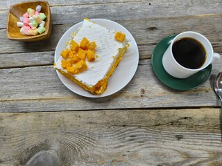 delicious piece of cake. Delicious dessert with layers of sponge cake next to a cup of coffee