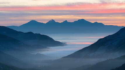 Fototapeta premium Misty Sunrise Over Mountain Peaks
