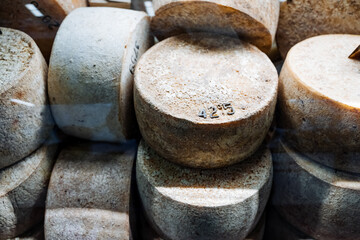 A delightful assortment of various cheese pieces has been meticulously arranged in a neatly stacked...