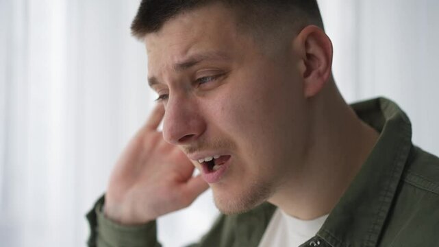 Hearing problems.
A man with poor hearing.
A man cannot hear when people speak quietly.
The man has an ear injury.