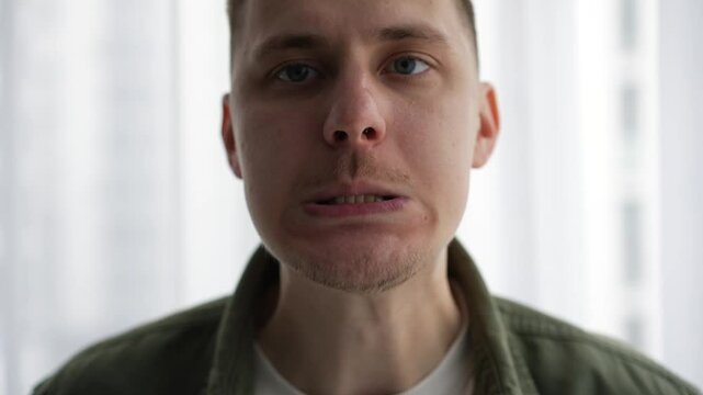 Mouth facial expressions.
A man warms up his speech apparatus.
Massage your mouth before a performance.
Oratory art.
The announcer stretches his mouth for clear diction