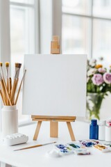 Creative artist's workspace with canvas and painting supplies beside a sunlit window