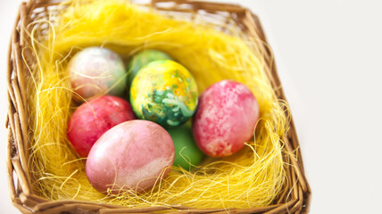 Easter eggs in a basket. Traditional Easter decoration and food.