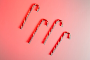 Minimal composition with christmas lollipops on color background, top view
