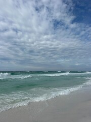 Destin, Florida beach with fluffy white clouds 