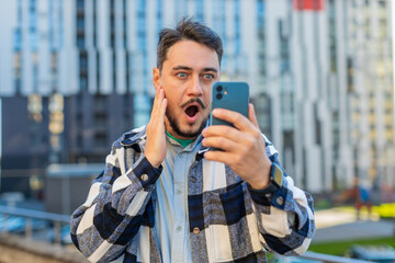 Happy shocked excited Caucasian mature man tourist in casual clothes mouth opened celebrate victory...