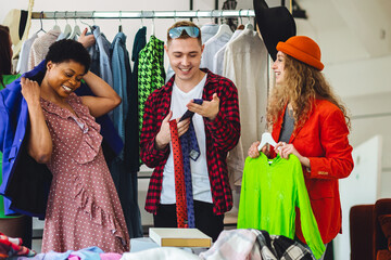 Home swap party. Young people, generation z exchanging clothes, branded clothing, accessories. Bargain hunting, pre-owned goods, thrift store, second hand. Sustainable eco friendly consumerism