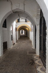 passageway with a series of arches and whitewashed walls, creati
