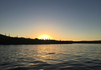 Naklejka premium Sunset over a lake with a desert horizon