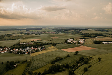 Obraz premium Drone view during sunset over a wide area of fields