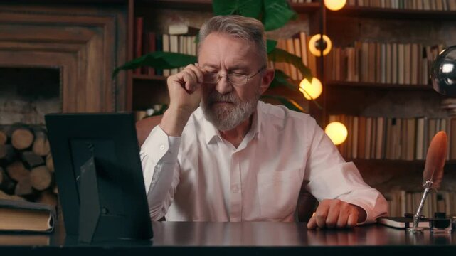 Caucasian old man looking examing framed photo thinking pensive pensioner home inside businessman business nostalgia dream contemplation elderly male takes off glasses picture office memory moments