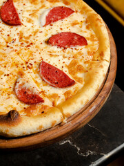 Sausage pizza on tray isolated close up