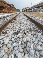 Naklejka premium Close up of Railway tracks and stone ballast,Hua Hin railway station,Thailand.