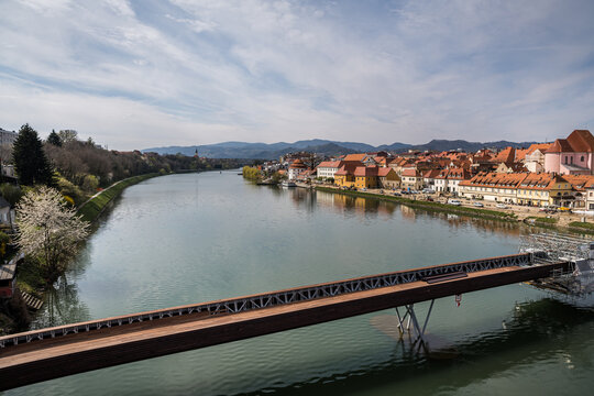 Construction of the Splavarska Footbridge (Splavarska brv) over the Drava River in Maribor, Slovenia, captured on a bright April day.