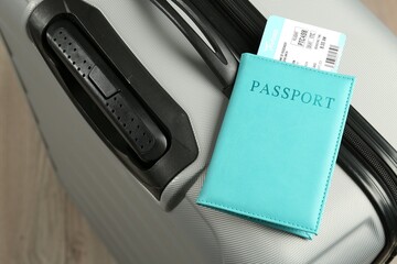 Passport with ticket on gray suitcase, closeup