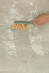 Woman sweeping the floor after renovation 