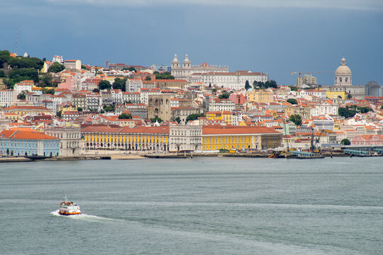 Beautiful view of the city of Lisbon, Almada, cacilheiro boats crossing the Tagus River. - Powered by Adobe