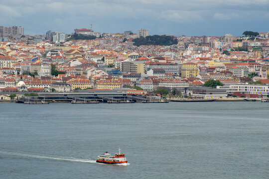 Beautiful view of the city of Lisbon, Almada, cacilheiro boats crossing the Tagus River.