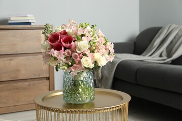 Beautiful bouquet of fresh flowers on coffee table in room, space for text