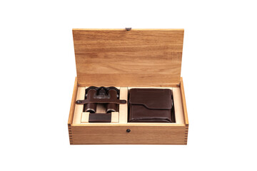 A wooden box with an open lid reveals a set of binoculars and a leather case, both neatly placed in compartments, showcasing a luxurious and organized presentation
