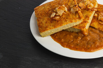 Oven-baked potato pancakes with mushroom sauce and onions
