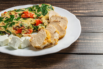 Hot breakfast of eggs, fresh vegetables, delicious chicken and tender cheese