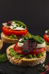 Vegan food concept, rice cakes with fresh vegetables on black background