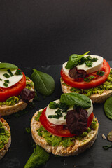 Vegan food concept, rice cakes with fresh vegetables on black background