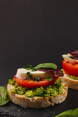 Vegan food concept, rice cakes with fresh vegetables on black background
