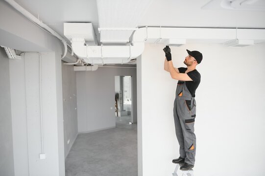 Ventilation cleaning. Specialist at work. Repair ventilation system HVAC