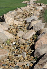 Dry streambed creek bed lined with large rocks
