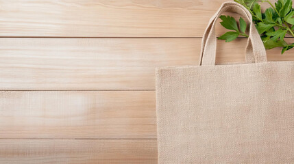 Natural jute bag on wooden surface with green leaves, eco friendly choice