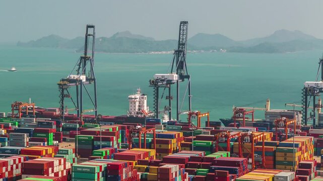 SHENZHEN, CHINA - NOVEMBER 7, 2024: Busy port operations with cargo ships and containers in Shenzhen during the midday sun