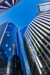 skyscraper buildings in business district, London City. Blue sunny day sky. Low angle view. Europe financial economy, merger and acquisition, or modern architecture concept, vertical