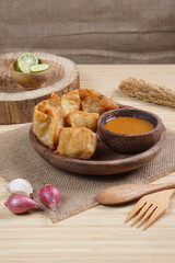 batagor,is a street food that is very popular in Indonesia.made from fish, tapioca and seasoning wrapped in dumplings then fried. Served with spicy peanut sauce. photographed with studio light