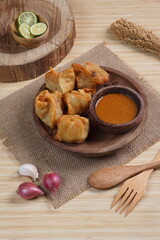 batagor,is a street food that is very popular in Indonesia.made from fish, tapioca and seasoning wrapped in dumplings then fried. Served with spicy peanut sauce. photographed with studio light
