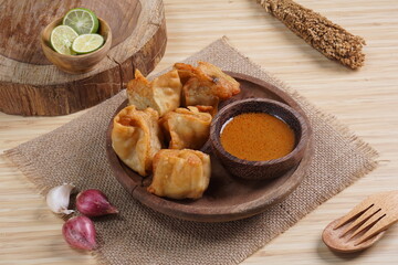 batagor,is a street food that is very popular in Indonesia.made from fish, tapioca and seasoning wrapped in dumplings then fried. Served with spicy peanut sauce. photographed with studio light