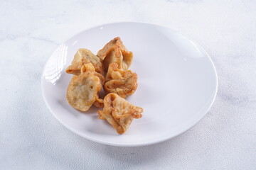 batagor,is a street food that is very popular in Indonesia.made from fish, tapioca and seasoning wrapped in dumplings then fried. photographed with studio light