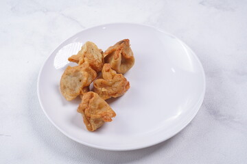 batagor,is a street food that is very popular in Indonesia.made from fish, tapioca and seasoning wrapped in dumplings then fried. photographed with studio light