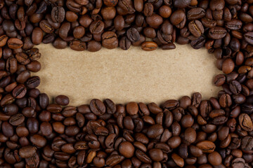 Roasted coffee beans framing blank kraft paper space