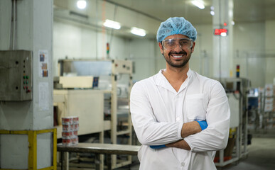 Portrait of production control supervisor inspects and controls the operation of each step in the production line of a canned fish factory