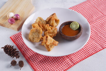batagor,is a street food that is very popular in Indonesia.made from fish, tapioca and seasoning wrapped in dumplings then fried. Served with spicy peanut sauce. photographed with studio light