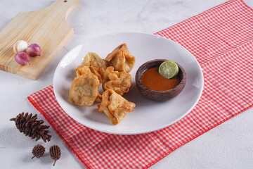 batagor,is a street food that is very popular in Indonesia.made from fish, tapioca and seasoning wrapped in dumplings then fried. Served with spicy peanut sauce. photographed with studio light