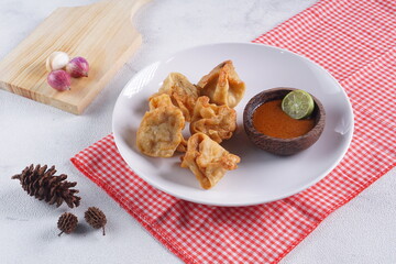 batagor,is a street food that is very popular in Indonesia.made from fish, tapioca and seasoning wrapped in dumplings then fried. Served with spicy peanut sauce. photographed with studio light