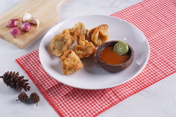 batagor,is a street food that is very popular in Indonesia.made from fish, tapioca and seasoning wrapped in dumplings then fried. Served with spicy peanut sauce. photographed with studio light