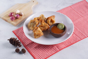 batagor,is a street food that is very popular in Indonesia.made from fish, tapioca and seasoning wrapped in dumplings then fried. Served with spicy peanut sauce. photographed with studio light
