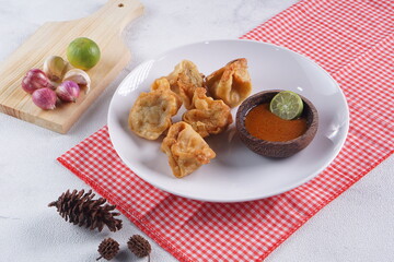 batagor,is a street food that is very popular in Indonesia.made from fish, tapioca and seasoning wrapped in dumplings then fried. Served with spicy peanut sauce. photographed with studio light